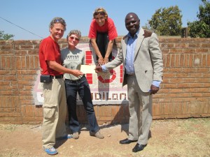 Marcel and Demelza thank us for our work in front of the new AYISE sign.